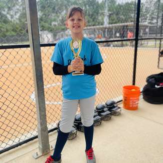 softball player holding a trophy