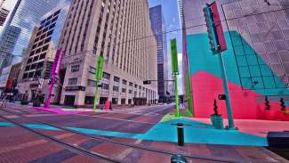 Colorful intersection of a city block with large painted murals and art elements