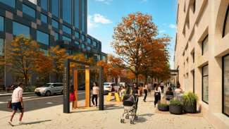 Streetscape showing an artistic metal wayfinding sign.