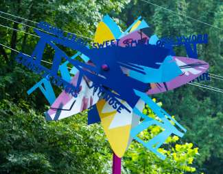 Colorful, artist-designed bus shelters and a sculptural bench along Poole Road and at the Neuse River trailhead. 