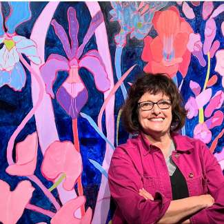 a headshot of julia with a floral background