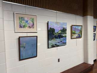 paintings in a variety of mediums on display 