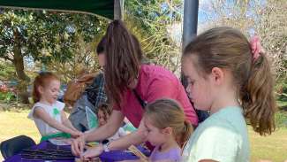 kids and an adult volunteering