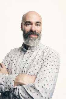 Image of artist Matthew Mazzotta looking at the camera with his arms crossed.