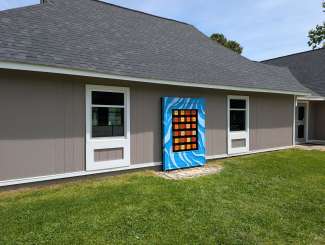 The Turning Phrases artwork installed on the outside wall of the Eastgate Park community center