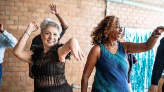 a woman dancing with her friends on a dance hall