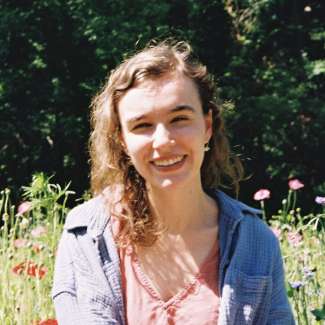 a headshot of Katie Bushman with flowers in the background