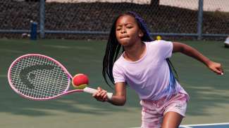 Young girl playing tennis
