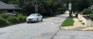 picture of car driving over speed hump