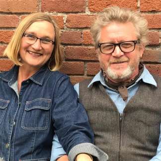A woman and a man smile at the camera