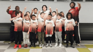 Group of young wrestlers with their coaches